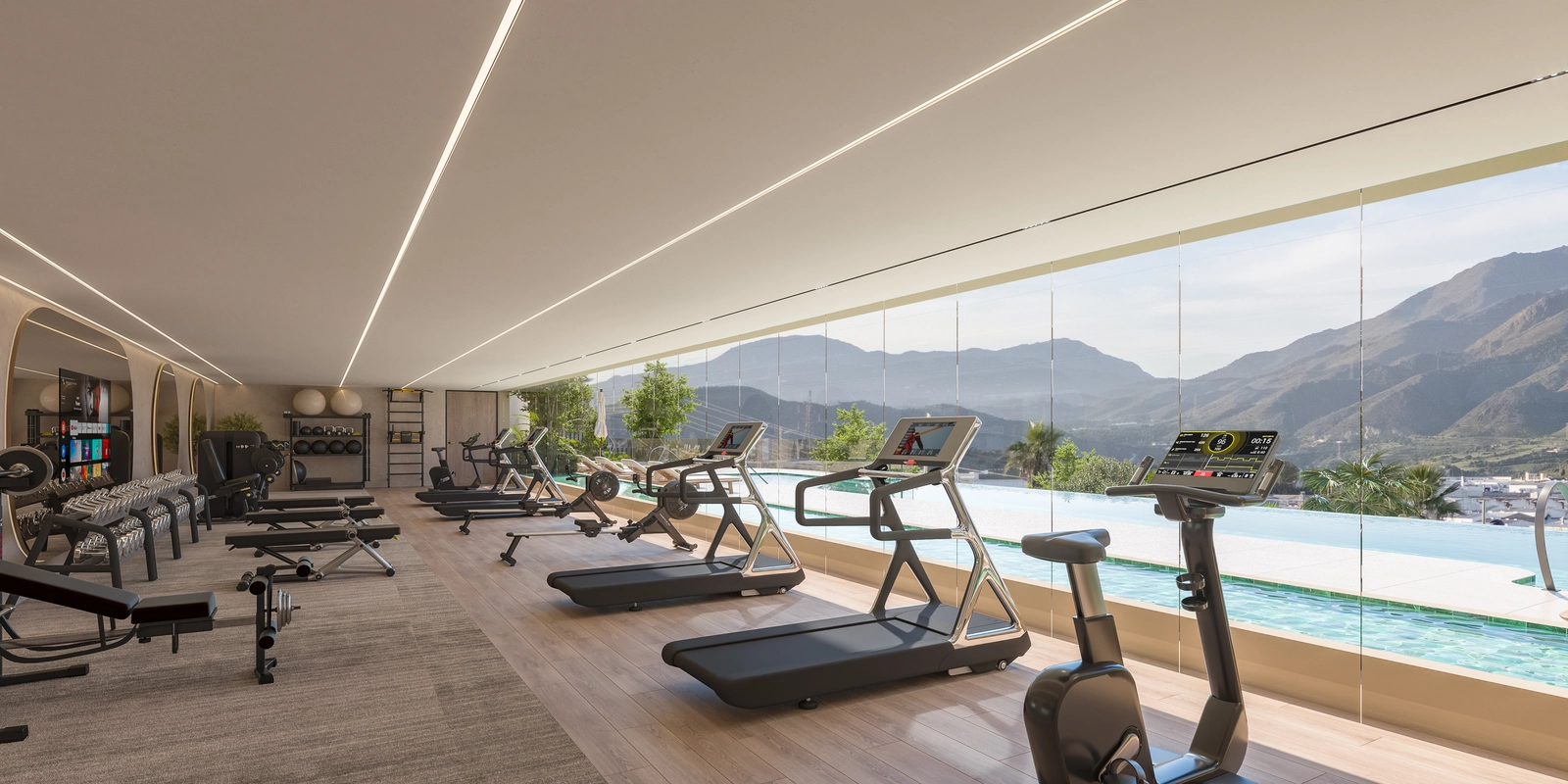 Det toppmoderne treningssenteret, fullt utstyrt og med utsikt over bassenget og fjellene for en inspirerende treningsøkt.