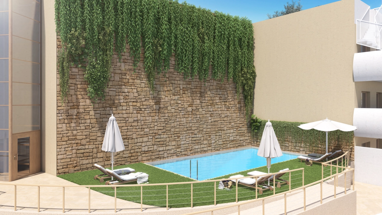 Et av de to innbydende utendørs svømmebassengene, plassert i vakkert anlagte felleshager.