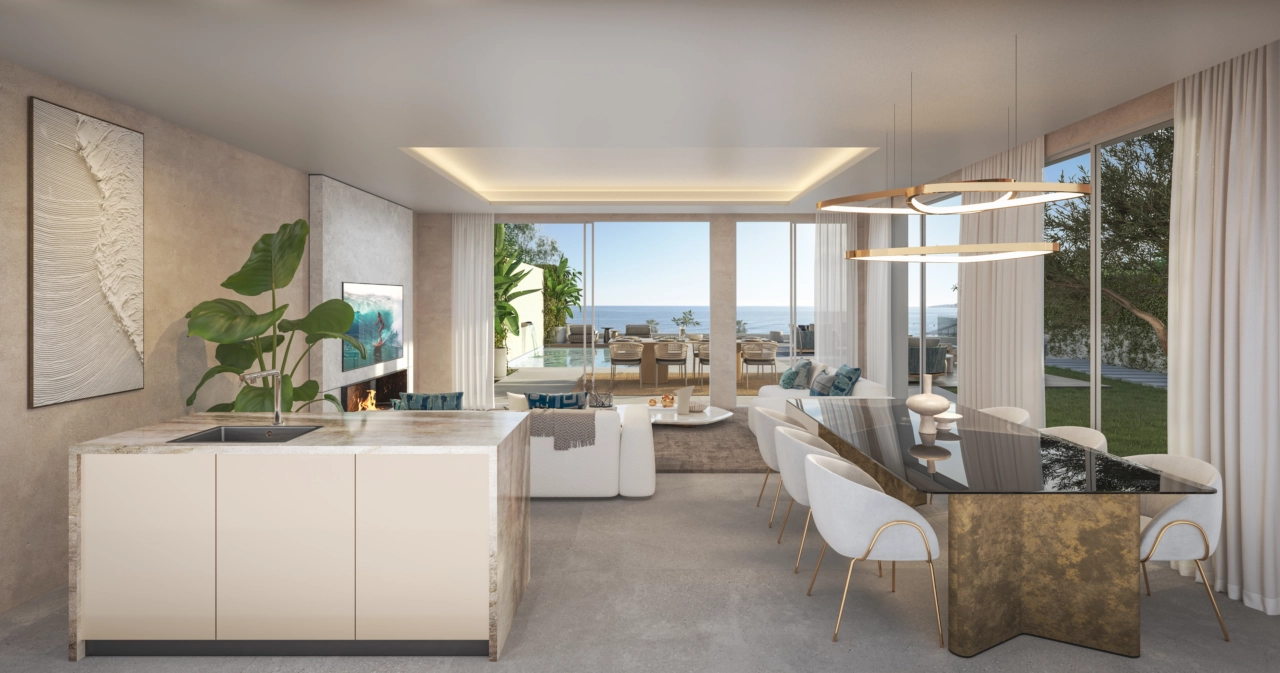 En åpen stueløsning som sømløst forbinder innendørs med utendørs og havet.